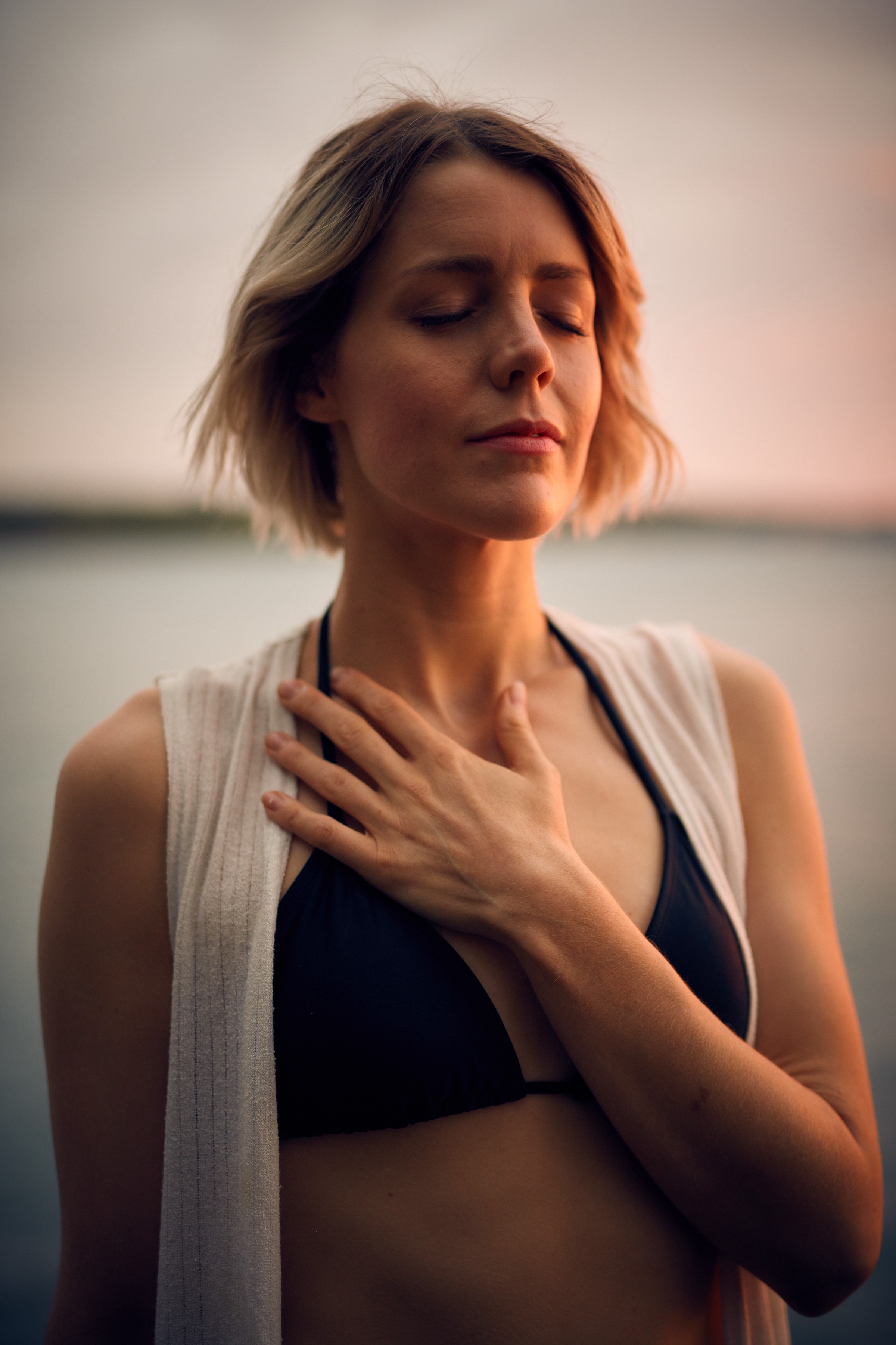 A woman holding her hand to her heart.